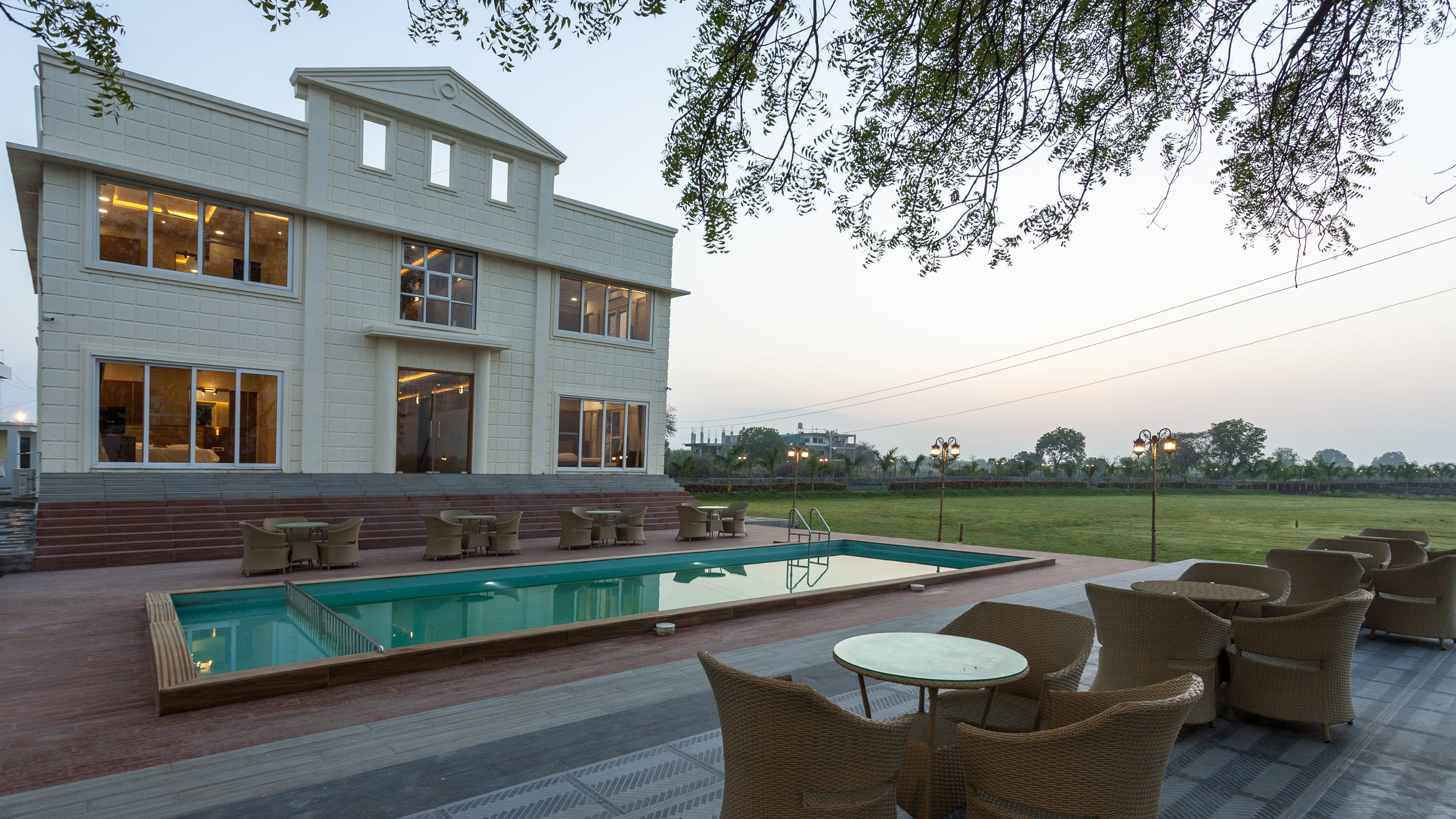 Poolside seating and lawn at bungalow in Nanded, best hotels in Nanded Maharashtra for family room in Nanded stays